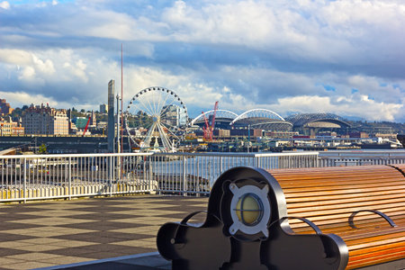 A bench at the Pier 66 with panorama of Puget Sound shore in Seattle, USA. Late afternoon sun...