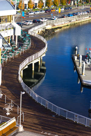 Pathway along the pier in Seattle downtown. Scenic view on the waters of Puget Sound in late afternoon in autumn.のeditorial素材