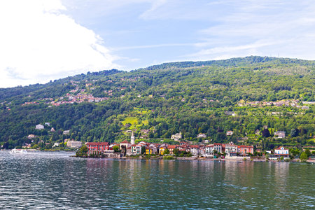 A town waterfront and suburban landscape on the Lake Maggiore in Northern Italy. Scenic panorama of...