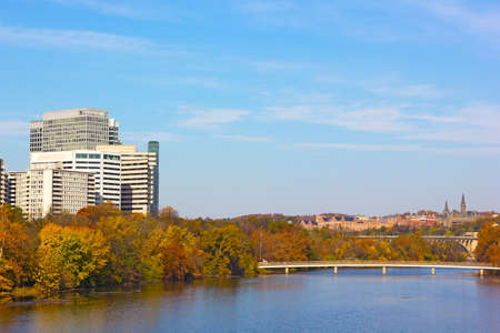 Autumn panorama of metropolitan Washington DC, USA. Modern and historic buildings and bridges across Potomac River with trees in a multicolor fall foliage.の写真素材
