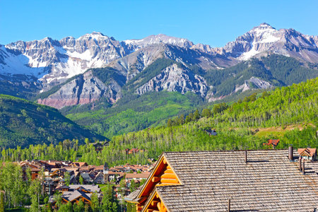 Telluride city panorama with snow mountain peaks and forestry hillsides. Beautiful town at high...