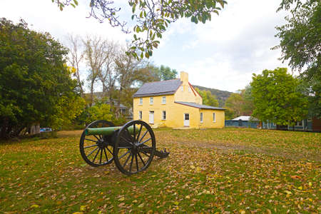 Historic battlefield cannon in Harpers Ferry, West Virginia, USA. Historic town in autumn with displayed old military artifact.の写真素材