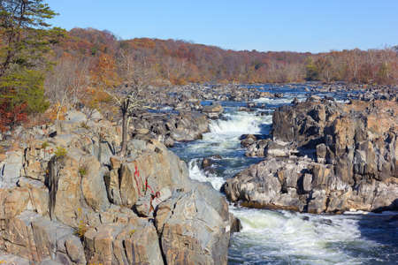 Potomac River in Great Falls state park in autumn, Virginia, USA. Falls in the river and trees in fall colors.の写真素材