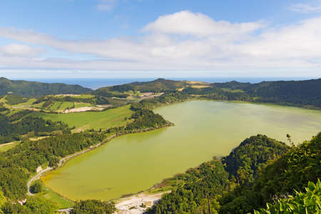 Aerial view on the lake Lagoa das Furnas near Furnas, Sao Miguel, Azores, Portugal. Countryside landscape with Atlantic Ocean on the horizon.の写真素材