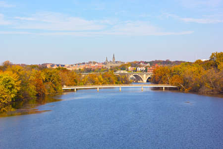 Autumn colors in Georgetown, Washington DC. A view on Georgetown University from Roosevelt Bridge over Potomac River.の写真素材