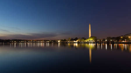 Washington Monument across Tidal Basin during cherry blossom festival, Washington DC. Washington Monument on dark blue night sky background in the dusk.のeditorial素材