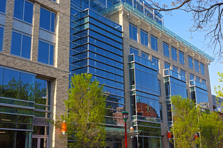 Modern development of Chinatown neighborhood of Washington DC, USA. Reflections of historic church in windows of multistory building.のeditorial素材