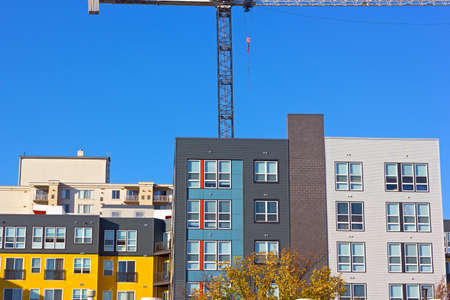 Modern urban development in suburbs of Washington DC. Newly build residential community under a blue clear sky.の写真素材