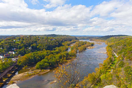 Aerial view on a trail along Potomac River and buildings near Harpers Ferry railway station. Panoramic view on Harpers Ferry National Historic Park in autumn, West Virginia, USA.の写真素材