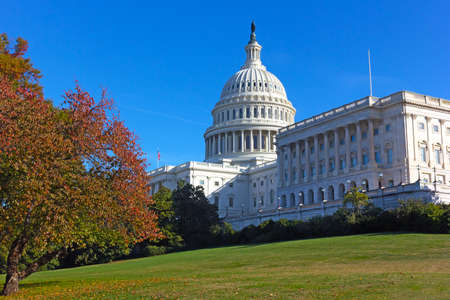 Autumn colors near the United States Capitol building in Washington DC, USA. US Capitol dome recently undergone the multi-year restoration project to repair the cast iron.の写真素材