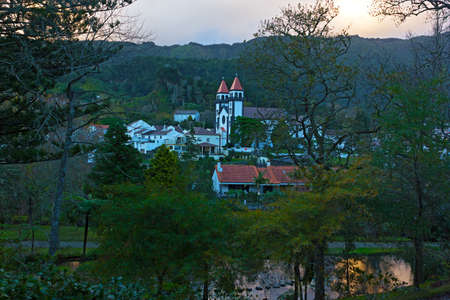 Furnas at sunset, Sao Miguel, Azores, Portugal. Village church and surrounding mountains at dusk.の写真素材