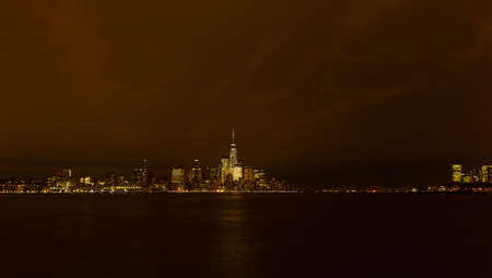 Panorama of Manhattan across Hudson River at night, New York City. Brightly lit New York skyscrapers during winter holiday season.の写真素材