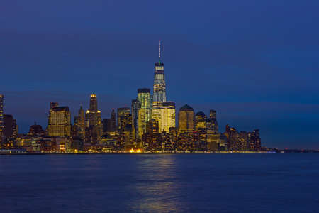 Low Manhattan skyline at night with reflection in Hudson River. New York urban panorama on a clear night in winter.のeditorial素材