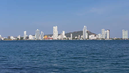 Modern Cartagena along the sea shoreline beaches. Scenic view from the sea harbor on the modern multistory buildings in Cartagena, Colombia.の写真素材