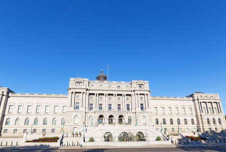 Grand historic architecture of The Library of Congress, Thomas Jefferson Building in Washington DC, USA. Joggers take a break on the library steps under clear blue skies when august heat felt even in the early morning hours.のeditorial素材