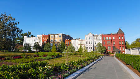 Residential urban environment of US capital. Colorful residential buildings surrounded by garden plants in the heart of Washington DC, USA.のeditorial素材