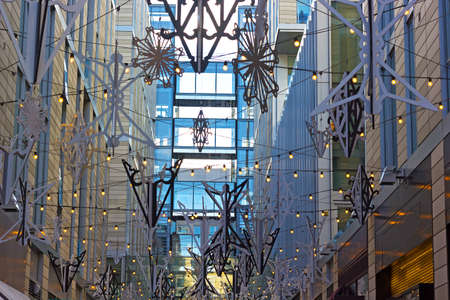 Decorated pedestrian alley in Washington DC downtown, USA. Winter decorations are in harmony with modern urban architecture.の写真素材