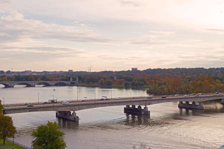 Washington DC panorama along Potomac River at sunset in the fall, USA. Urban landscape with bridges, cars and recreational park area near the Potomac River.の写真素材