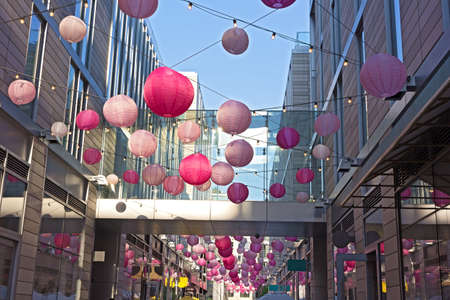 DC City Center festive spring atmosphere accompanies cherry blossom events in Washington DC, USA. City Center features boutiques and restaurants along pedestrian alley brighten by pastel colored balloons.の写真素材