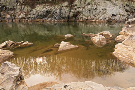 Beauty and magic of Potomac River waters in the Great Falls Park, Maryland, USA. Rocky riverbanks on a calm winter afternoon.の写真素材