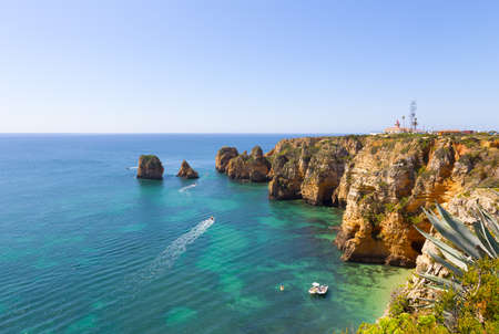 Panoramic overlook of Ponta de Piedade at Lagos, Portugal. Watersport activities in sea waters near the cliffs and caves.の写真素材