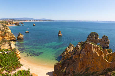 Panorama of the coastline in Lagos, Portugal. A secluded sandy beach surrounded by the Ponta de Piedade cliffs.の写真素材