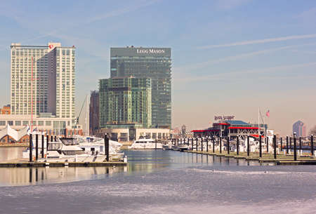 BALTIMORE, USA - JANUARY, 31, 2014: Docked yachts, Rusty Scupper restaurant, Legg Mason Tower and Marriott hotel at the Inner Harbor in Baltimore downtown on January 31, 2014. Urban winter scene of Inner Harbor in Baltimore.のeditorial素材