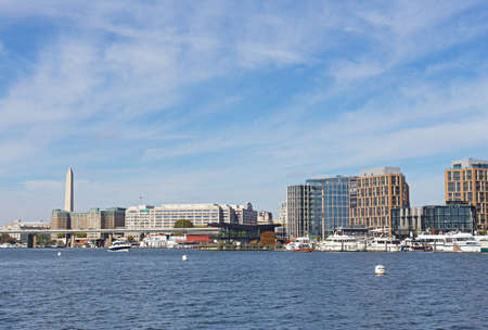 WASHINGTON DC, USA - OCTOBER 28, 2017: The Wharf of US capital with marina and a view on Washington Monument. District Wharf designed as broad promenade with new living, shopping and entertainment venues.のeditorial素材