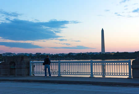 WASHINGTON DC, USA - JULY 28, 2018: Photographer takes a shot of Tidal Basin in US capital city at dawn. Cityscape with buildings and Washington Monument before summer sunrise.のeditorial素材