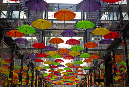 Colorful umbrellas on downtown street in Washington DC, USA. Umbrellas create a cozy friendly atmosphere on the street with shops and restaurants in US capital.の写真素材