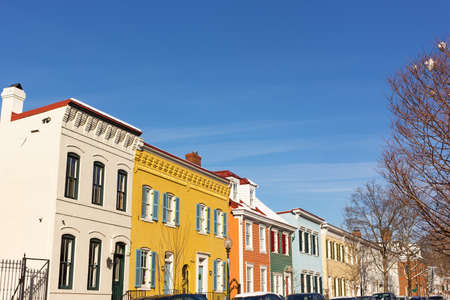 Brightly painted houses on the street of Washington DC neighborhood, USA. Residential houses in close proximity to the Georgetown University.の写真素材