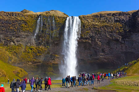 Overcrowded tourist destinations â at Skogafoss waterfall in South Iceland. Over-tourism is a new emerging trend.のeditorial素材