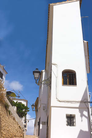 Residential architecture of modern houses in a hilly landscape. Geology of mountainous region shapes a residential neighborhood in Spanish town.の写真素材