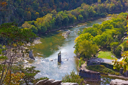A view on The Point where Potomac and Shenandoah rivers meet in Harpers Ferry National Historic Park. Park landscape in autumn with remains of old bridge.の写真素材