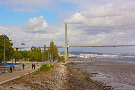 LISBON, PORTUGAL â OCTOBER 16, 2019: Vasco da Gama bridge and pedestrian walkway along Tagus River with the capital city on horizon.のeditorial素材