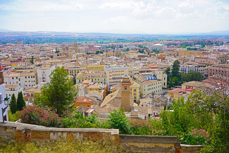 Panoramic view from the city evevated point on old town of Granada and mountains on horizon, Spain....