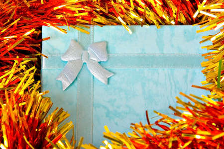 Christmas gift with ribbon on colorful  decorationsの写真素材