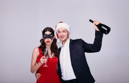 Beautiful loving couple wearing evening outfit. Happy young couple in love celebrate the New Year...