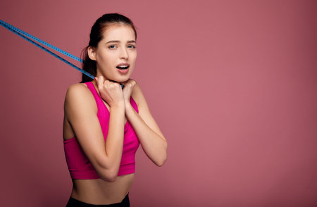 A young fit athletic brunette with big blue eyes and full lips in sportswear screams and runs...