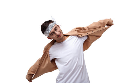 Image of an emotional man in summer bandana looking to the side of a dance isolated. Funny cheerful young white guy with glasses isolated on a white background.の写真素材
