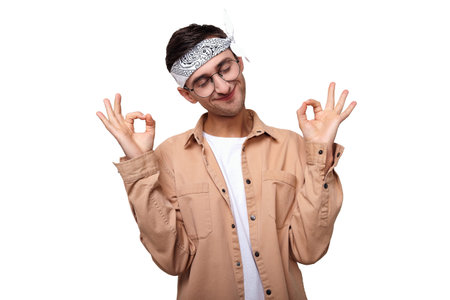 Balanced, calm, happy guy in a white T-shirt and beige shirt, in round glasses, closed his eyes,...