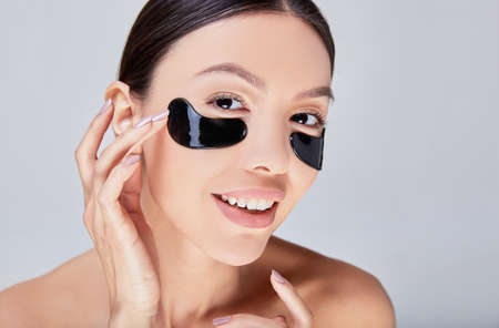 Cosmetic mask for the skin under the eyes. False eye mask on an Asian girl with perfect healthy skin.の写真素材