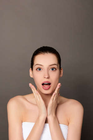 Beautiful woman skin care concept face beuty close up healthy clean skin. Young charming brown-haired woman with blue eyes, with nude makeup.の写真素材