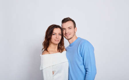 Head shot studio portrait smiling attractive millennial couple in love looking at camera, romantic relationships, young family wife and husband spouses, love and dating concept image.の写真素材
