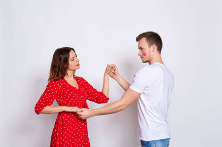Clean holiday! Big Poan, a young beautiful Caucasian couple, he and she, in elegant clothes bonding and dancing, standing on a white background.の写真素材