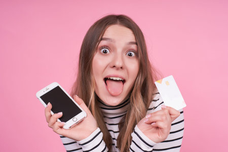 Portrait of a beautiful young caucasian girl with a funny face with open mouth and outstretched...