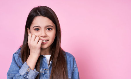 Attractive young funny emotional caucasian girl child long-haired brunette. Close-up, scared,...