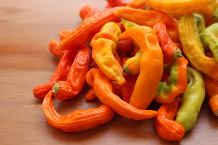 The multitude of hot chili on the wooden table with copy space with .