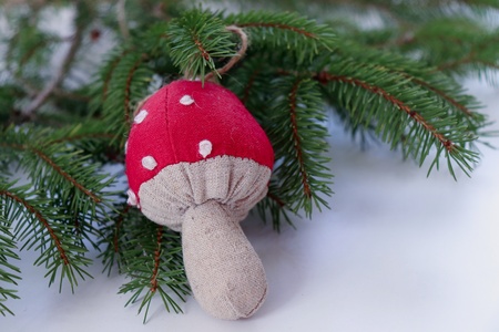 Closeup view cedar branches and Christmas decoration mushroom on a white background. Christmas background. Selective focus,the place for text.Blurred background.の写真素材