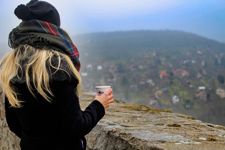 Young blond woman looking at the river. Concept of female beauty, rest in the nature,rear view.の写真素材